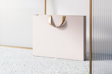 Poster - Perspective view on blank beige paper shopping bag with golden braid and place for your brand name or text on concrete floor and light wall background, close up. 3D rendering, mockup
