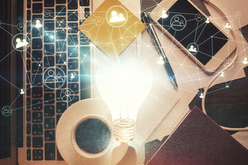 Poster - Bulb drawing over computer on the desktop background. Top view. Double exposure. Idea concept.