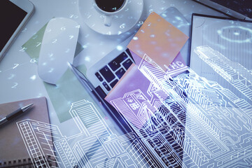 Poster - City drawing over computer on the desktop background. Top view. Double exposure. Smart home concept.