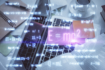 Physics and math theme hologram with formula drawings over computer on the desktop background. Top view. Multi exposure. Concept of education.