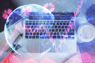 Fototapete - Business theme hologram drawings over computer on the desktop background. Top view. Multi exposure. Concept of international connections.