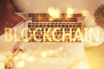 Poster - Blockchain theme hologram drawings over computer on the desktop background. Top view. Double exposure.