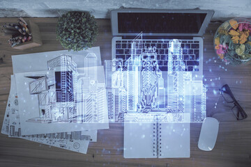 Poster - City drawing over computer on the desktop background. Top view. Double exposure. Smart home concept.