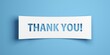Thank you text on white paper cut out over blue background, gratitude concept