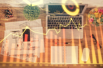 Poster - Stock market graph and top view computer on the table background. Double exposure. Concept of financial education.