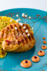 Poster - Fried chicken fillet with rice, carrots, onions, curry and sauce in plate.