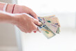 © simonmayer - Close-up of woman's hands holding bills of 50 thousand Colombian pesos and 100 dollars