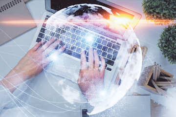 Wall Mural - Double exposure of woman hands working on computer and financial theme hologram drawing. Top View. Business concept.