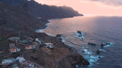 Wall Mural - Aerial sunset view of dramatic Atlantic Ocean coastline of Anaga, steep cliffs and small villages, Canary Islands, Spain