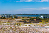 Fototapeta  - Gulf Islands National Seashore along Gulf of Mexico barrier islands of Florida. Fort Pickens on Santa Rosa Island. Pensacola Lighthouse, Pensacola Bay, Discovery Center, NAS Pensacola water towers.