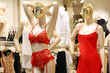Female mannequin in red bra and panties with suspenders, sexy outfit for Valentine's holiday. Different underwear in lingerie store