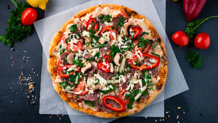 Wall Mural - Italian cuisine pizza with beef, mushrooms, tomatoes, sweet peppers, onions, cheese and parsley.