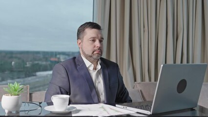 Poster - Happy businessman working on laptop in home office. financial investor working in the office. Accountant working on consolidated financial report of corporate operations.