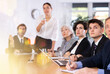 © JackF - Group of diverse business people attending meeting in conference room, discussing work plan