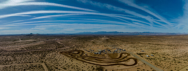 Panoramic overhead view of dirt motorcycle track in barren desert landscape in the Mojave desert