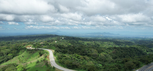 Wall Mural - Curvy road in green central america panorma