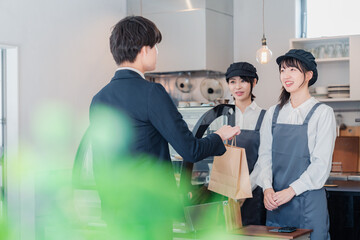 Poster - 洋菓子店でお菓子を買うビジネスマン