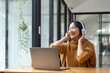 © Natee Meepian - Overjoyed millennial girl wearing headphones have fun moving listening to music relax on laptop