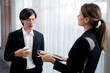 © NT_studio - Young manager talking with secretary about report marketing on digital tablet for planning at office, executive discussion with employee woman together, leadership and employee, business concept.