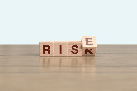 Wooden block cube flipping RISK to RISE