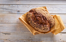 Freshly Baked Homemade Bread Lying On Wooden Surface