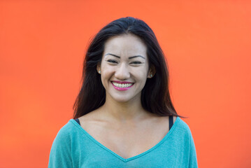 Wall Mural - Young asian female teen portrait on colored background