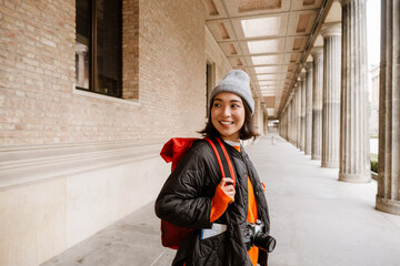 Young asian woman tourist walking through the old city street