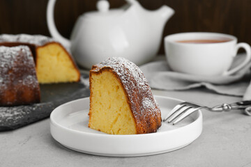Wall Mural - Piece of homemade yogurt cake with powdered sugar on light grey table