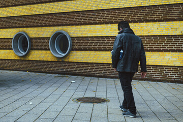 man in black leather jacket on the pavement