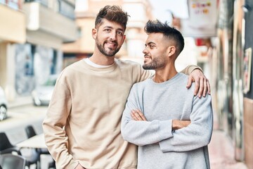 Young couple smiling confident hugging each other at street