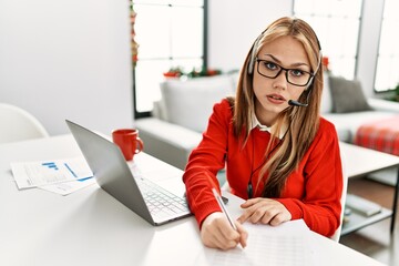 Sticker - Young caucasian woman call center agent teleworking sitting by christmas ornament at home