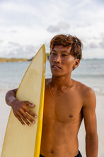 Indonesia, Lombok, Portrait Of Serious Male Surfer Against Sea�