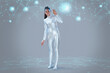 © IndiaPix - A woman wearing silver dress standing on a grey backdrop, next to virtual icons
