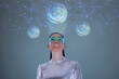 © IndiaPix - A model dressed as a robot wearing silver clothes and digital glasses, futuristic  clothes, with virtual icons . A future technology concept
