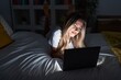 © Krakenimages.com - Young blonde woman using laptop lying on bed at bedroom