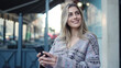 © Krakenimages.com - Young blonde woman smiling confident using smartphone at street