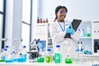 © Krakenimages.com - African american woman scientist writing report working at laboratory