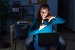 © Krakenimages.com - Brunette woman working at the office at night smiling making frame with hands and fingers with happy face. creativity and photography concept.