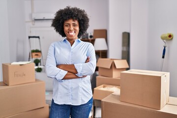 African american woman smiling confident standing with arms crossed gesture at new home