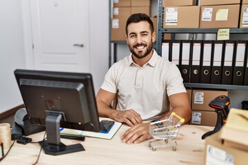 Sticker - Handsome hispanic man working at small business commerce with a happy and cool smile on face. lucky person.