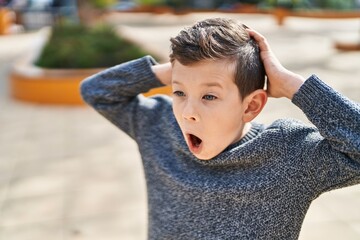 Poster - Blond child standing with surprise expression at park