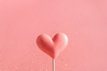 Wall Mural - Pink Valentine's day heart shape lollipop candy on empty pastel paper background. Love Concept