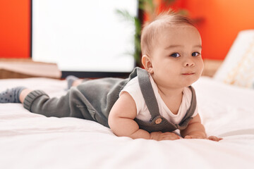 Sticker - Adorable hispanic toddler smiling confident lying on bed at bedroom