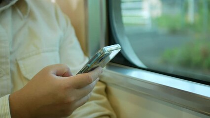 Canvas Print - A man in a commuter train subway metro traveling and uses the smartphone happy tourist travel by train  Freedom trip on vacation time holiday weekend