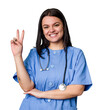 Young nurse woman isolated showing number two with fingers.