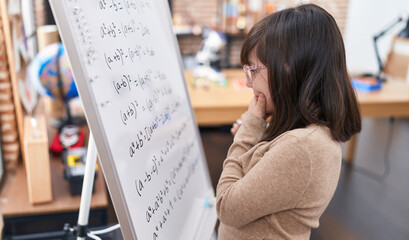 Poster - Adorable hispanic girl student standing by chalkboard solving maths exercise at classroom