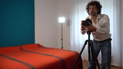 Wall Mural - Italy, Milan - Real estate photographer man taking professional pictures and video of the bedroom for real estate agency - home staging to sell the house - renting a home for tourist  traveller 