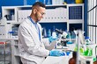 © Krakenimages.com - African american man scientist smiling confident weighing pills at laboratory