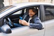 © Krakenimages.com - Middle age man using smartphone sitting on car at street