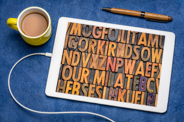 Sticker - alphabet abstract - random vintage letterpress printing blocks on a screen of digital tablet